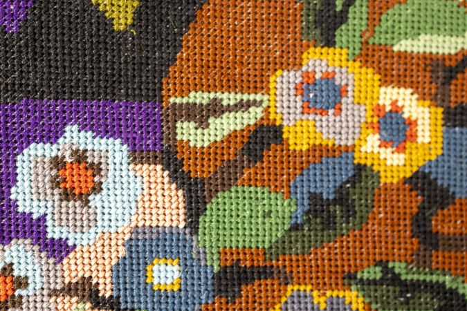 Upcycled embroidered textile mounted as a contemporary wall panel for interior spaces